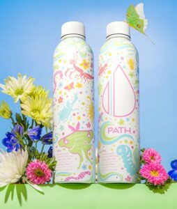PATH x Exceptional Minds limited-edition water bottle, staged with flowers